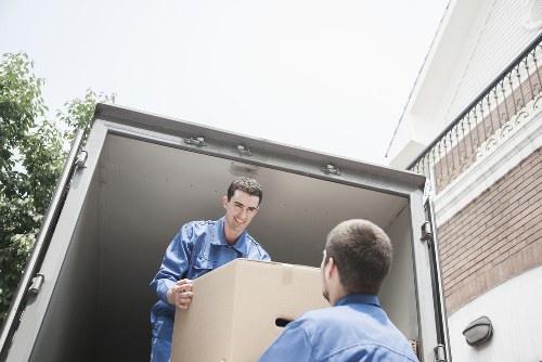 Packed boxes and furniture ready for transport by a removals van